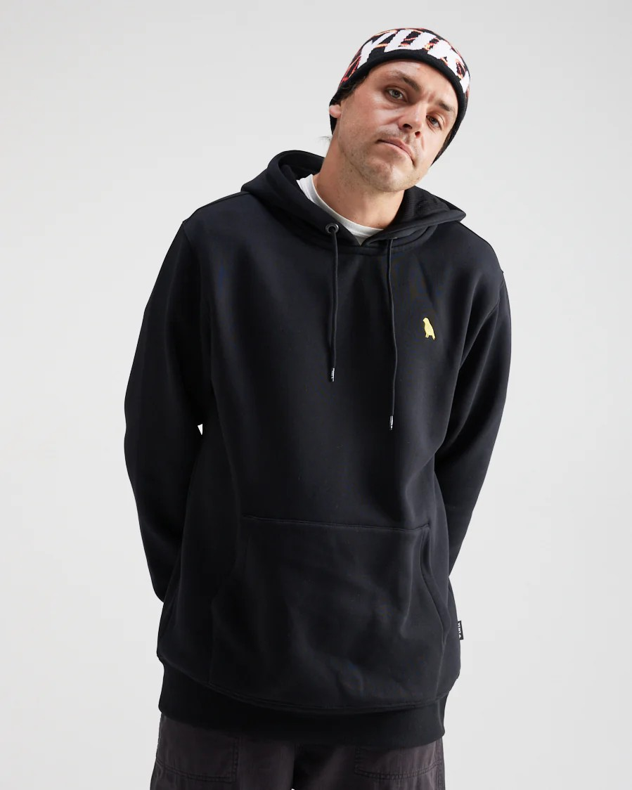 Person wearing a black hoodie with a small yellow logo on a light gray background